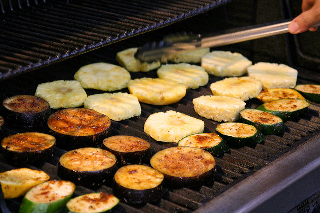Zucchini, eggplant and pineapples being grilled