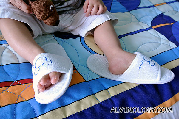 Asher in his baby size Disney bedroom slippers