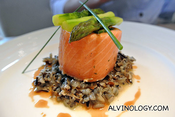 Confit of Salmon Roulade with Soft Herbs, Wild Rice, Hazelnut Oil and Poultry Jus