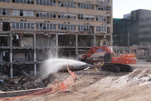 Spraying water over the rubble to control the dust