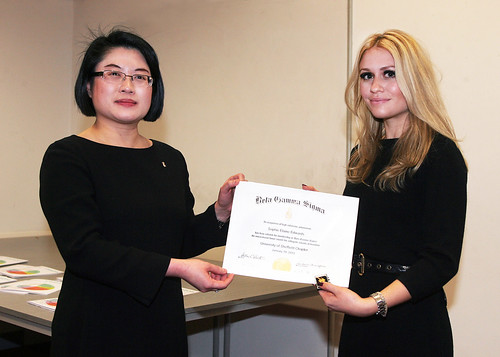 Professor Lenny Koh presents Sophie Edwards, BA Hons in Business Management, with her Beta Gamma Sigma membership certificate