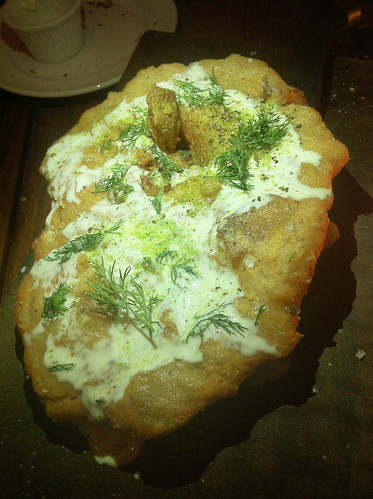 Like a giant, savory funnel cake. Langos: fried potato bread with garlic, sour cream and scallion