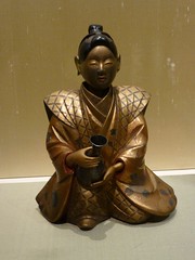 Sake Bottle in the Shape of A Young Man Holding a Bottle of Sake