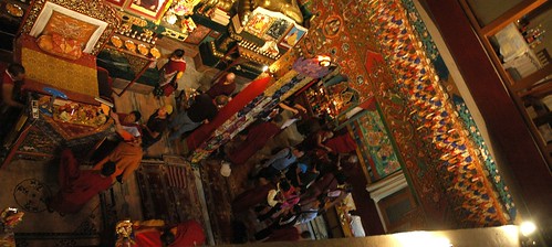 After the initiation and prayers, monks attend to the lama's table, sangha chats about religion and spirituality, traditional decor, Tharlam Monastery of Tibetan Buddhism, Boudha, Kathmandu, Nepal by Wonderlane