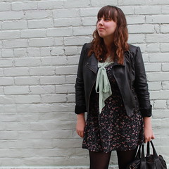 Rosemint outfit: black tights, black quilted boots, rosebud open-back dress, mint green sheer bow-tie blouse, studded-bottom bag, leather motorcycle jacket