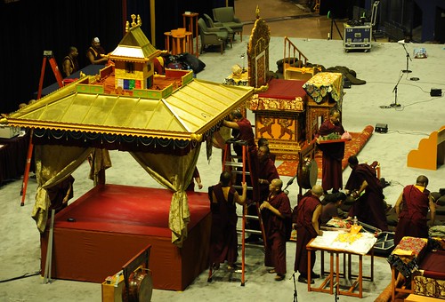Tibetan Buddhist monks assembling the golden Kalachakra pavilion for the intiation, ladder, planning table with instructions, HH the Great 14th Dalai Lama's throne, on stage, Kalachakra For World Peace, Verizon Center, Washington D.C., USA by Wonderlane