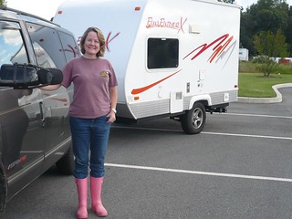 Teri Fahrendorf, president of the Pink Boots Society, stands in front of her truck and trailer wearing pink boots