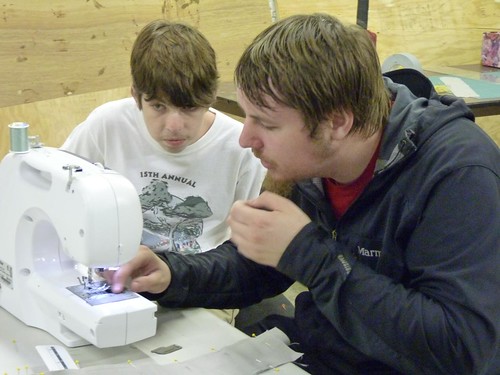 Ben and Ian sewing a sword cover