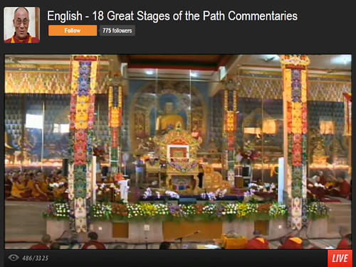 His Holiness the 14th Dalai Lama's throne, with traditional decorations, flowers, statue of Lord Buddha, 18 Great Stages of the Path Commentaries, webcast interface, Dharamasala, India by Wonderlane