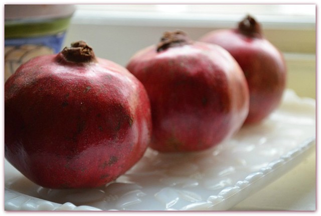 three pomegranates w background