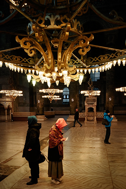 Muslim women under a great chandelier in Hagia Sophia museum