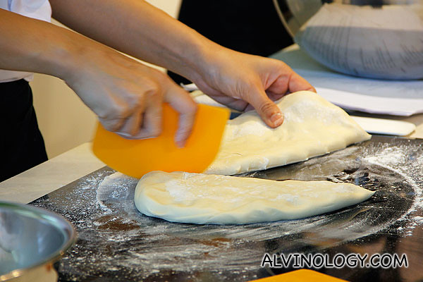 Chef Wendy trimming the dough into individual servings 