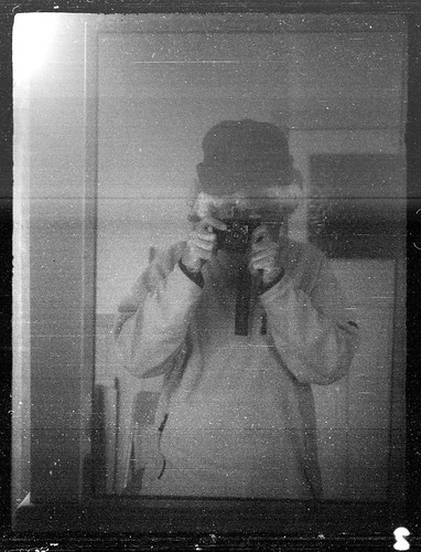 reflected self-portrait with Nagel Vollenda camera and wooly hat by pho-Tony