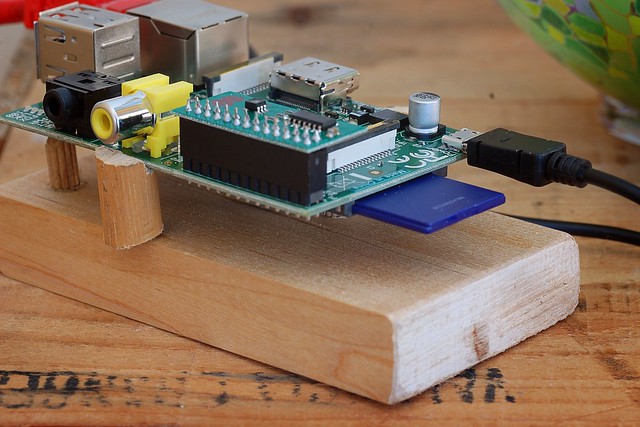 A Raspberry Pi mounted on a piece of wood