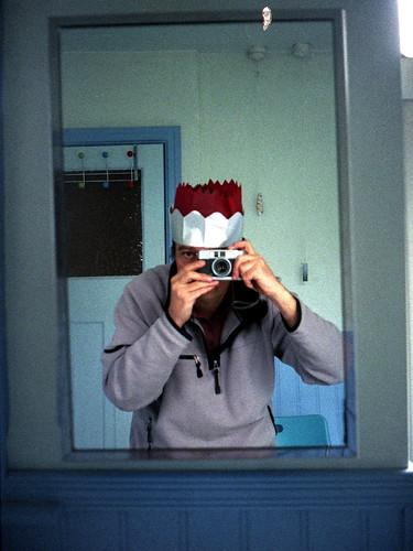 reflected self-portrait with Yashica Mimy camera and xmas hats on 12th night by pho-Tony