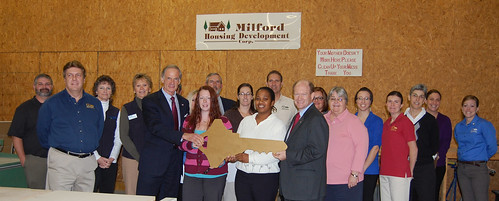 A key to home ownership:  Senator Tom Carper (center left) and  Senator Christopher Coons (center right) with Self-help participant Erin Moyer, and Self-help homeowner Latonya Smith.  Joining them are staff from USDA and Milford Housing Development Corp. Photos courtesy of Sen. Carper’s office.  