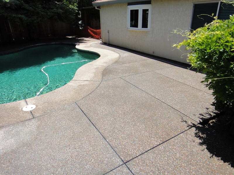 Plum Creek Exposed Aggregate Patio Added To Pool Deck