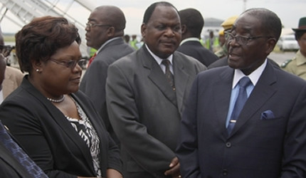 President Mugabe bids farewell to Vice President Joice Mujuru and Chief Secretary to the Presidency and Cabinet Dr Misheck Sibanda before his departure for South Africa at the Harare International Airport on March 7, 2013. by Pan-African News Wire File Photos