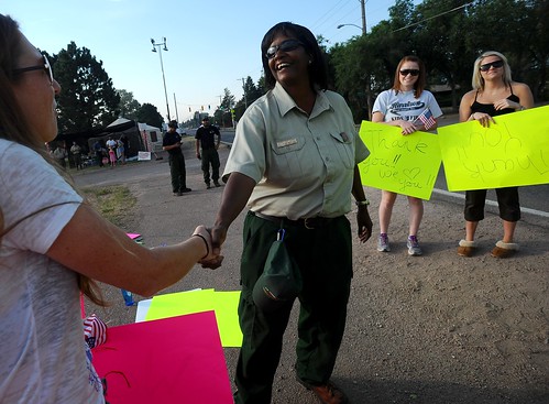 Jerri Marr, forest supervisor for the U.S. Forest Service, greets the crowd that gathered to thank the firefighters returning and leaving the fire camp Tuesday morning, July 3, 2012,  at Holmes Middle School in Colorado Springs, Colo. The Waldo Canyon Fire is now 70 percent contained.  (The Gazette, Christian Murdock) 