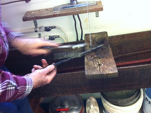 Cleaning the metal rod to re-cast a letterpress roller
