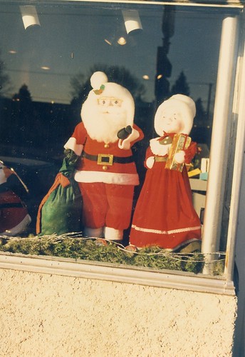 Mister and Mrs Santa Claus figures on display in a West 95th Street store wiindow.  Evergreen Park Illinois.  Early January 1988. by Eddie from Chicago