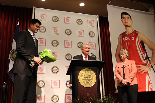 February 15th, 2013 - Yao Ming holds a bouquet of flowers given to him by a little girl at the City of Houston ceremony honoring him