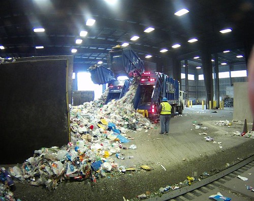 Collections Field Staffer Kelly Boyle observes incoming recyclables