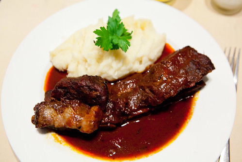 Braised short ribs in ancho chile and guava sauce, served with mashed potatoes