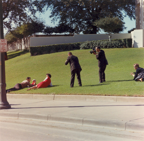 Bill and Jean Newman and their children fall on the grass north of Elm Street seconds after the assassination of U.S. President John F. Kennedy in Dallas, Texas, believing that they are in the line of fire. Photo
