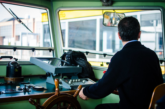 A vaporetto driver steers the water bus through Venice's Grand Canal.