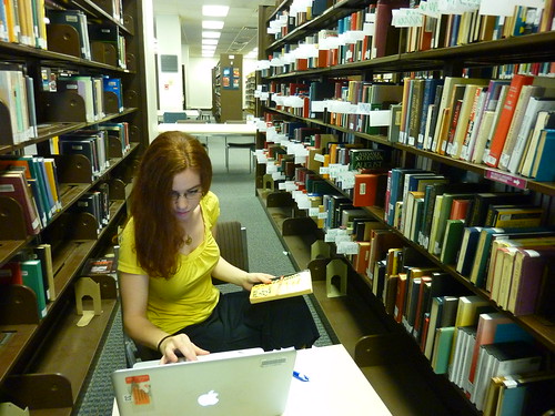 Image of graduate assistant working on weeding in the stacks