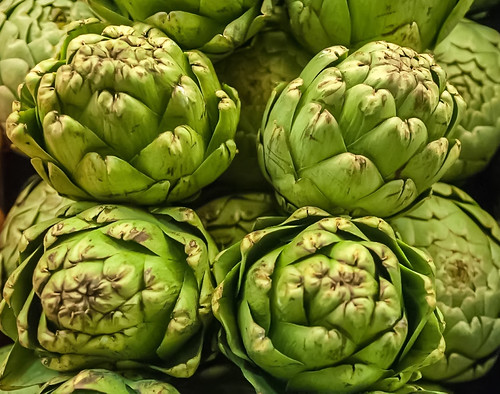 Pile of Artichoke on display at a farmers market by DigiDreamGrafix.com