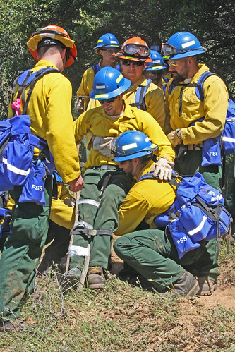 Firefighter trainees practice rescuing an injured firefighter during the Forest Service and California Conservation Corps joint training session.  (U.S. Forest Service photo)