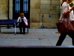 woman on a bench and strollers.