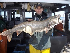 Green Bay FWCO Fish Biologist Kevin Pankow displays a lake trout captured gill netting near Isle Royale on Lake Superior