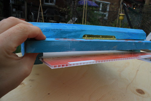 back of bottom board with hinged flap opened.