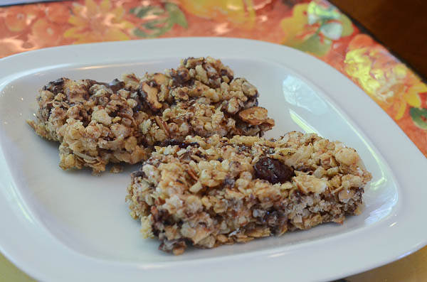 Two Cherry Dark Chocolate Granola Bars served on a plate.