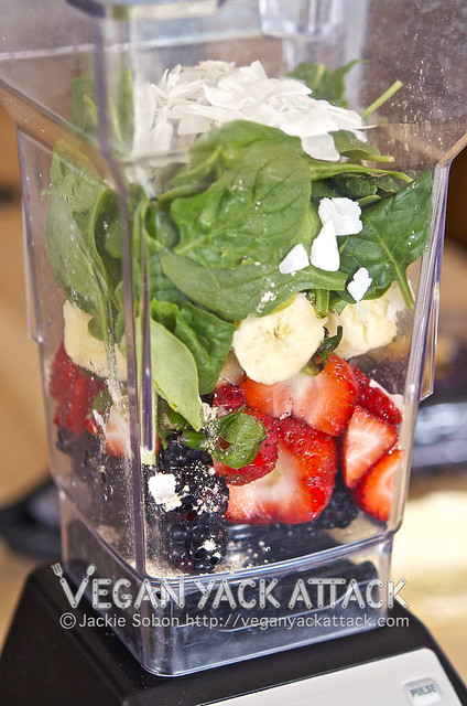 fruits and spinach in a blender before pureeing