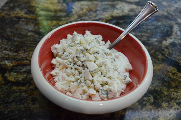 A small bowl with the Gorgonzola crumbles mixed with ranch dressing.