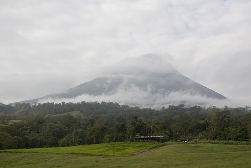 trees sky mountain green clouds farmhouse rural forest landscape volcano high costarica day moody wind cloudy farm smoke windy tall looming arenal matchpointwinner mpt210