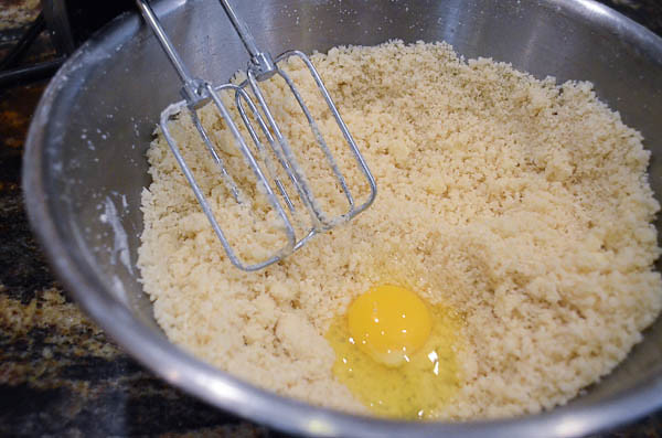 An egg is added to the mixed ingredients.