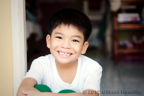 boy portrait people cute male boys childhood smiling kids children lens asian outdoors 50mm nikon day sitting child philippines young smiles manila innocence filipino nikkor frontdoor pinoy oneperson frontview whiteshirt headandshoulders brownhair 18d nikkorlens casualclothing 79years d90 lookingatcamera 50mm18d childrenonly oneboyonly 67years asianethnicity nikond90 valenzuelacity eastasianethnicity humanbodypart gilbertrondilla gilbertrondillaphotography luisianian gettyimagescollection gettyimagesphilippines frontdoorphotography