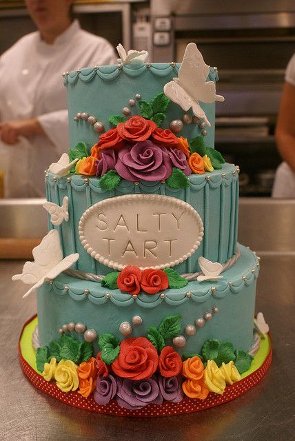 Blue Wedding Cake with Butterflies and Rainbow Flowers by Baker and Wife