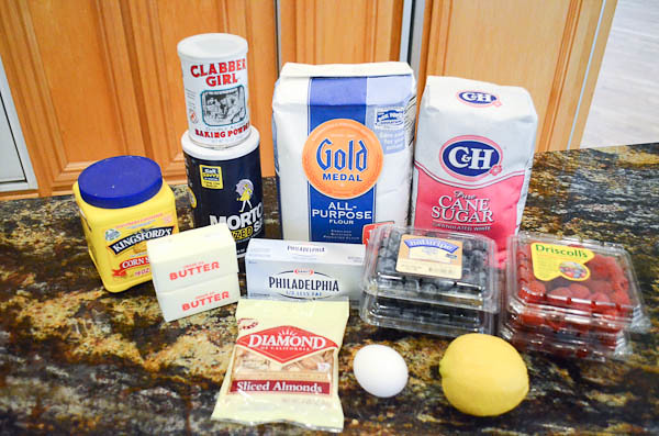 All the required ingredients to make Red White and Blue Bars arranged on a counter top.