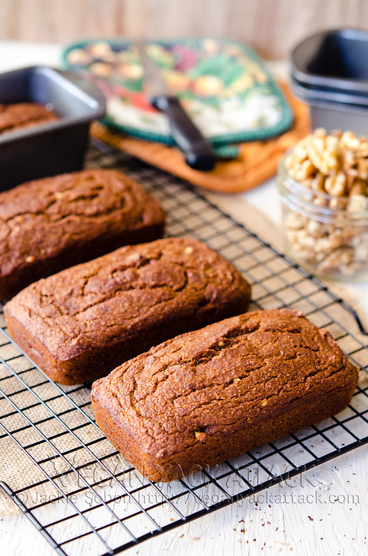 four small pumpkin bread loaves on a cooling rack