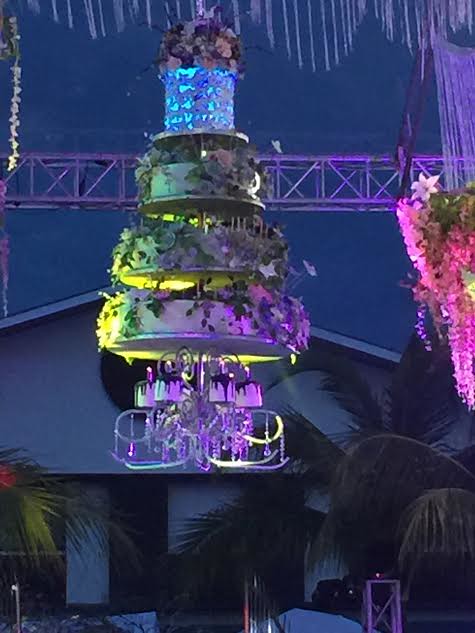 Ultimate Chandelier Cake suspended in mid air landed on a floating stage on a pool by Faye Sado of Faye's Golden Crown