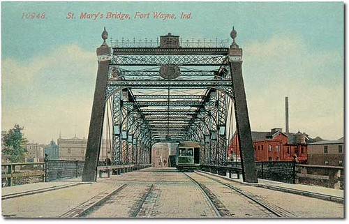 people usa man color men history industry fence buildings factory bridges indiana bicycles transportation rivers pedestrians streams interurban trolleys businesses fortwayne allencounty hoosierrecollections