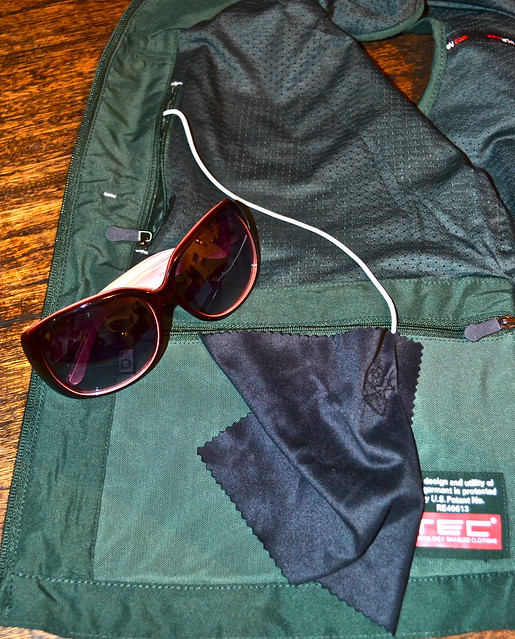 sunglass pocket with a cleaning cloth inside of a scottevest travel vest for woman