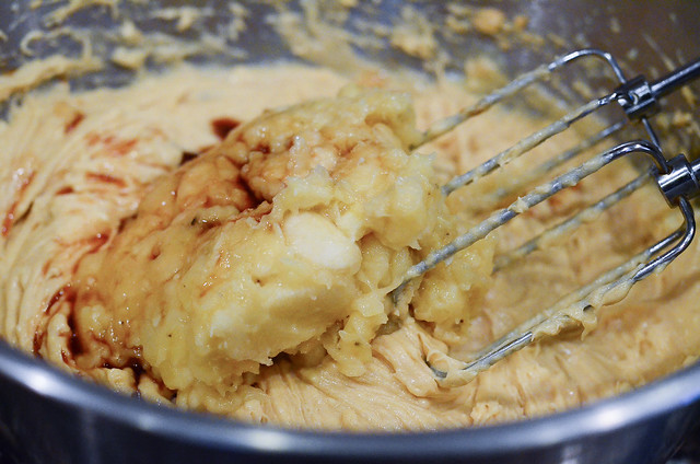 Mashed banana and vanilla extract are added to the wet ingredients.