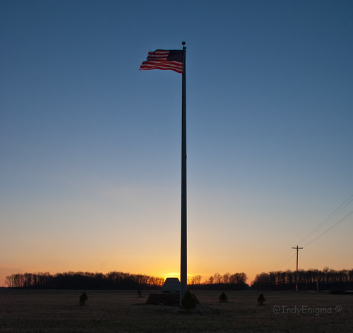 blue sunset sky orange silhouette flag pole utilitypole utilitywires